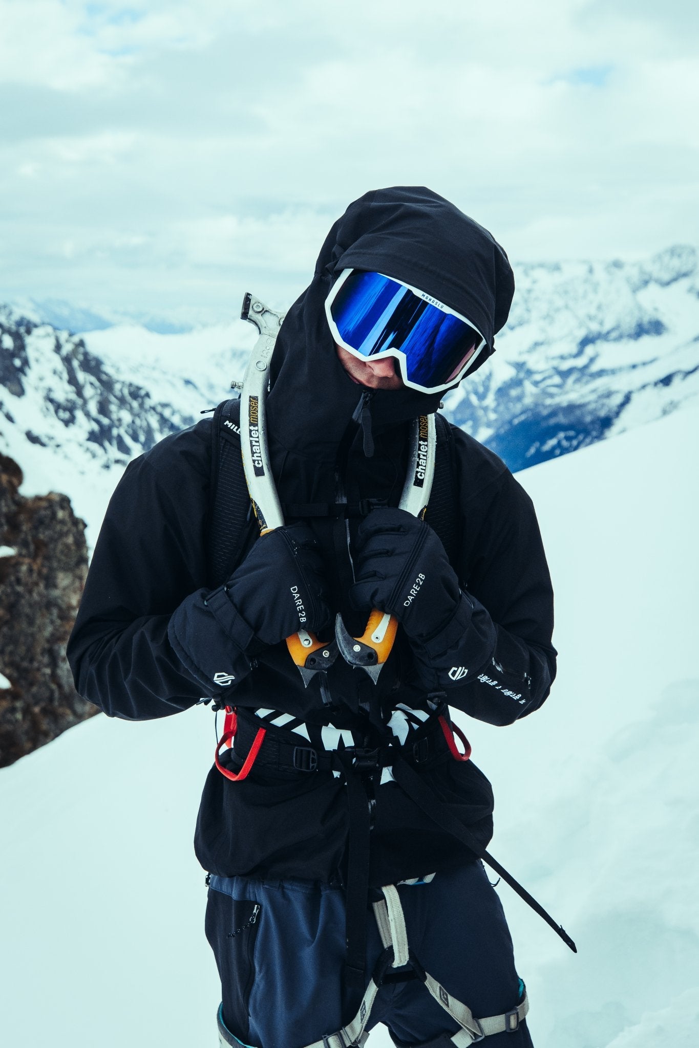 Climber wearing the black Manaslu Summit Shell alpine hardshell jacket in snowy mountain conditions